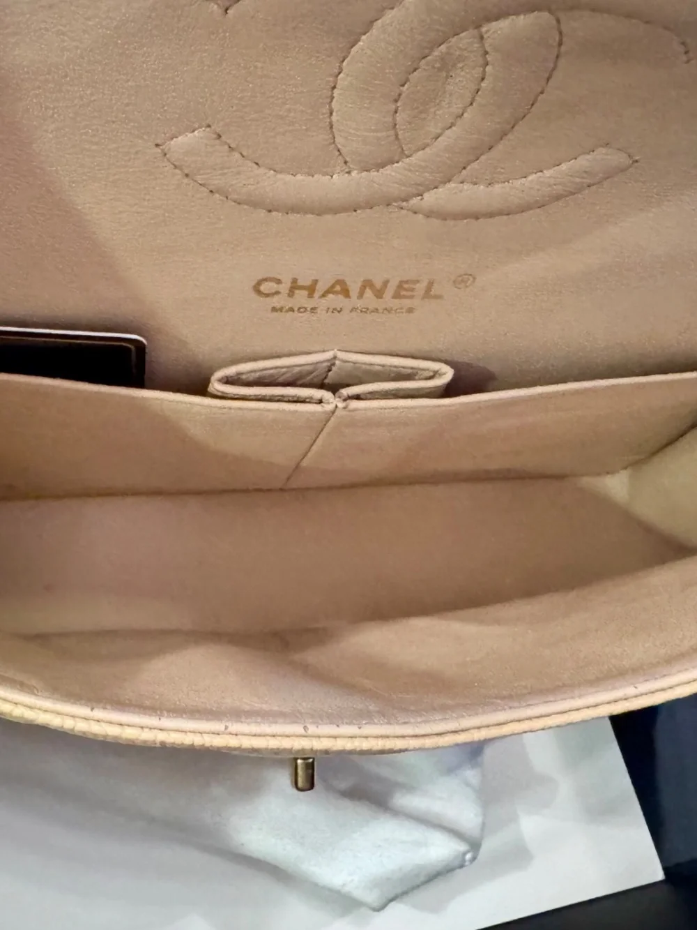 Chanel Classic Medium Double Flap in beige nude caviar with gold tone hardware.